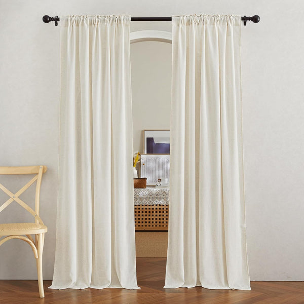 Pair of natural cream linen curtain panels with a gathered rod pocket top, hung over an arched opening.