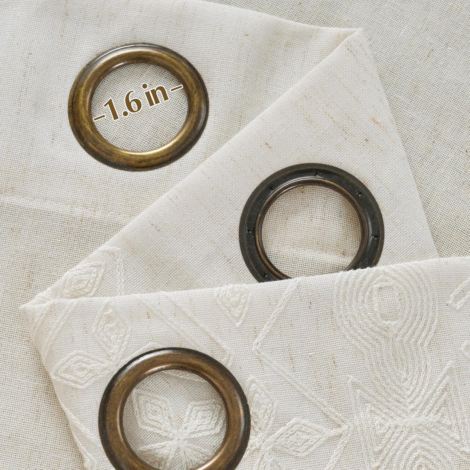 Natural linen curtains with 1.6 inch antique bronze grommets and white geometric embroidery.