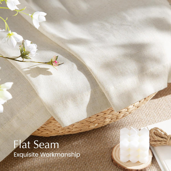 Close-up of natural light beige linen fabric with a visible, neatly stitched flat seam.