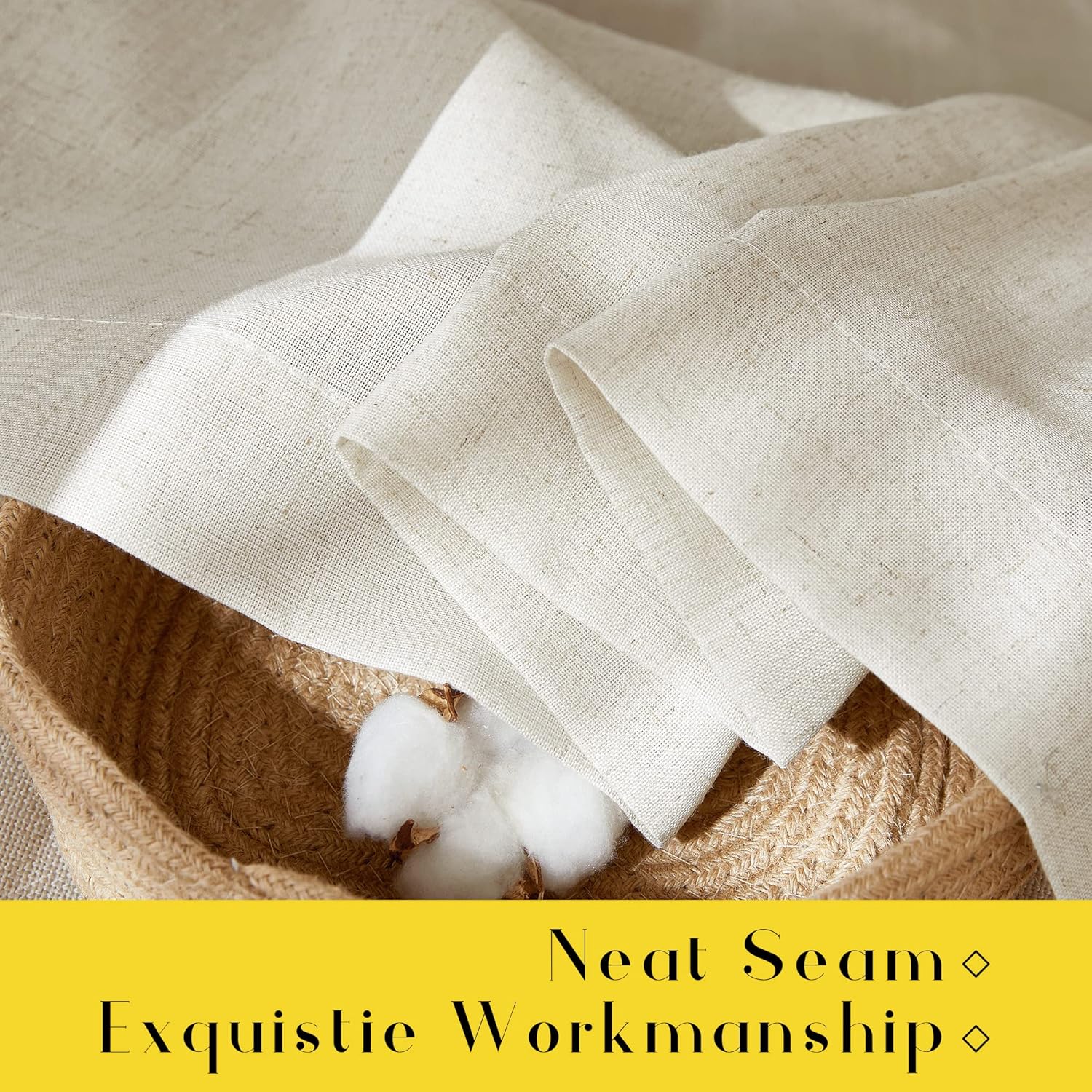 Close-up of light beige natural linen fabric with a visible, neat hem, folded inside a woven basket with cotton bolls.