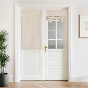 Natural linen tie-up and full panel shades covering white French door windows.