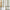 Light filtering natural linen curtain with olive green geometric and botanical embroidery by rustic window.