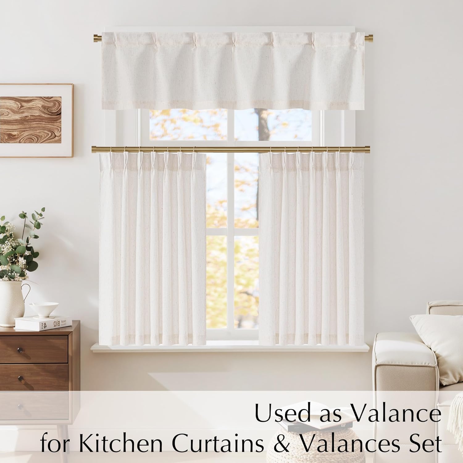 Off-white textured linen valance and cafe curtains with rod pockets on gold rods.