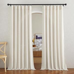 Natural linen pleated curtains hung from a black rod over an arched doorway, offering light filtering.