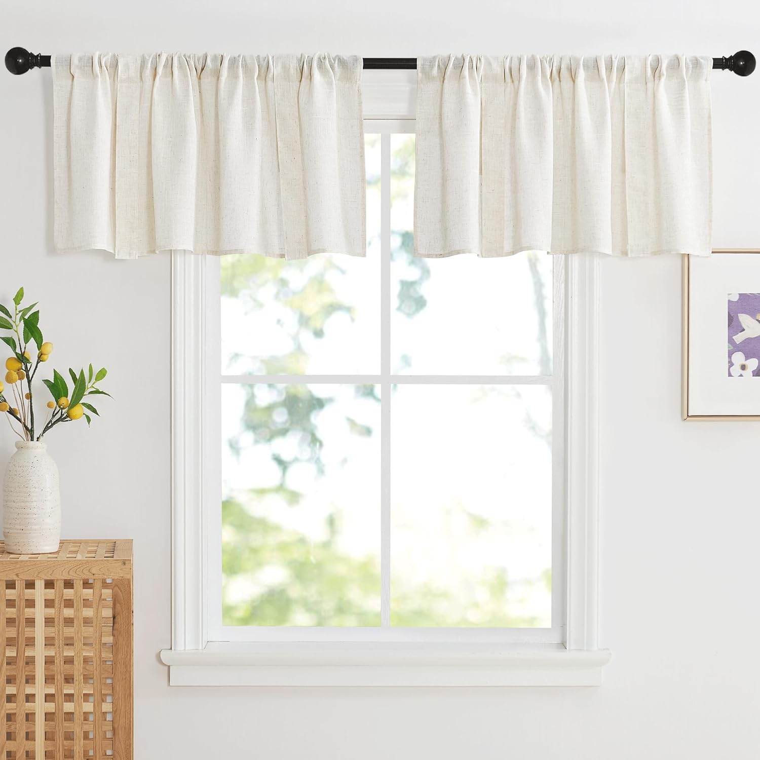 Natural off-white linen blend rod pocket valance hanging on a black rod over a window.