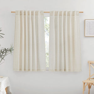 Two natural linen-blend tab top curtains provide soft light filtering over a window on a wooden rod.