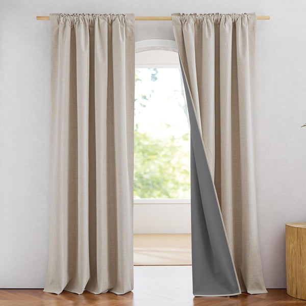Natural linen textured rod pocket curtains with dark grey blackout lining in a bright room.