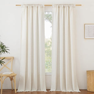 Natural cream linen blend curtains with a gathered rod pocket top hung on a wooden rod, providing soft light filtering.