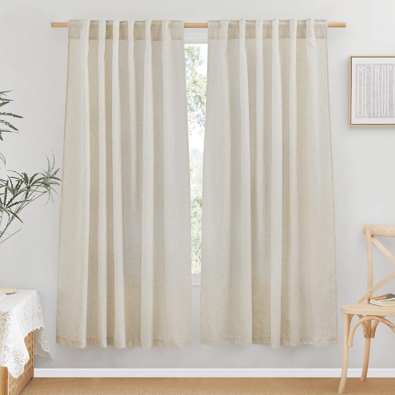 Two natural linen textured tab top curtains, offering soft light filtration in a bright room.