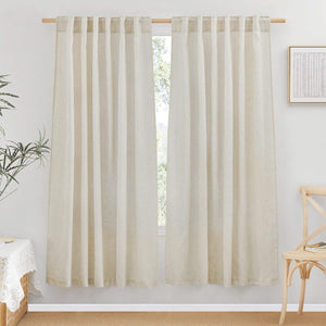 Two natural linen textured tab top curtains, offering soft light filtration in a bright room.