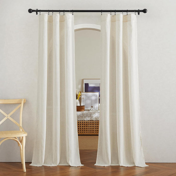 Pair of natural off-white linen light filtering curtains, pinch pleat top, hung on a black rod framing an arched doorway.