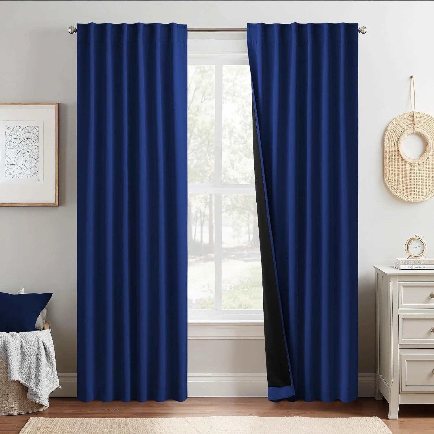 Navy blue blackout curtains on a bedroom window with soft pleats and black lining