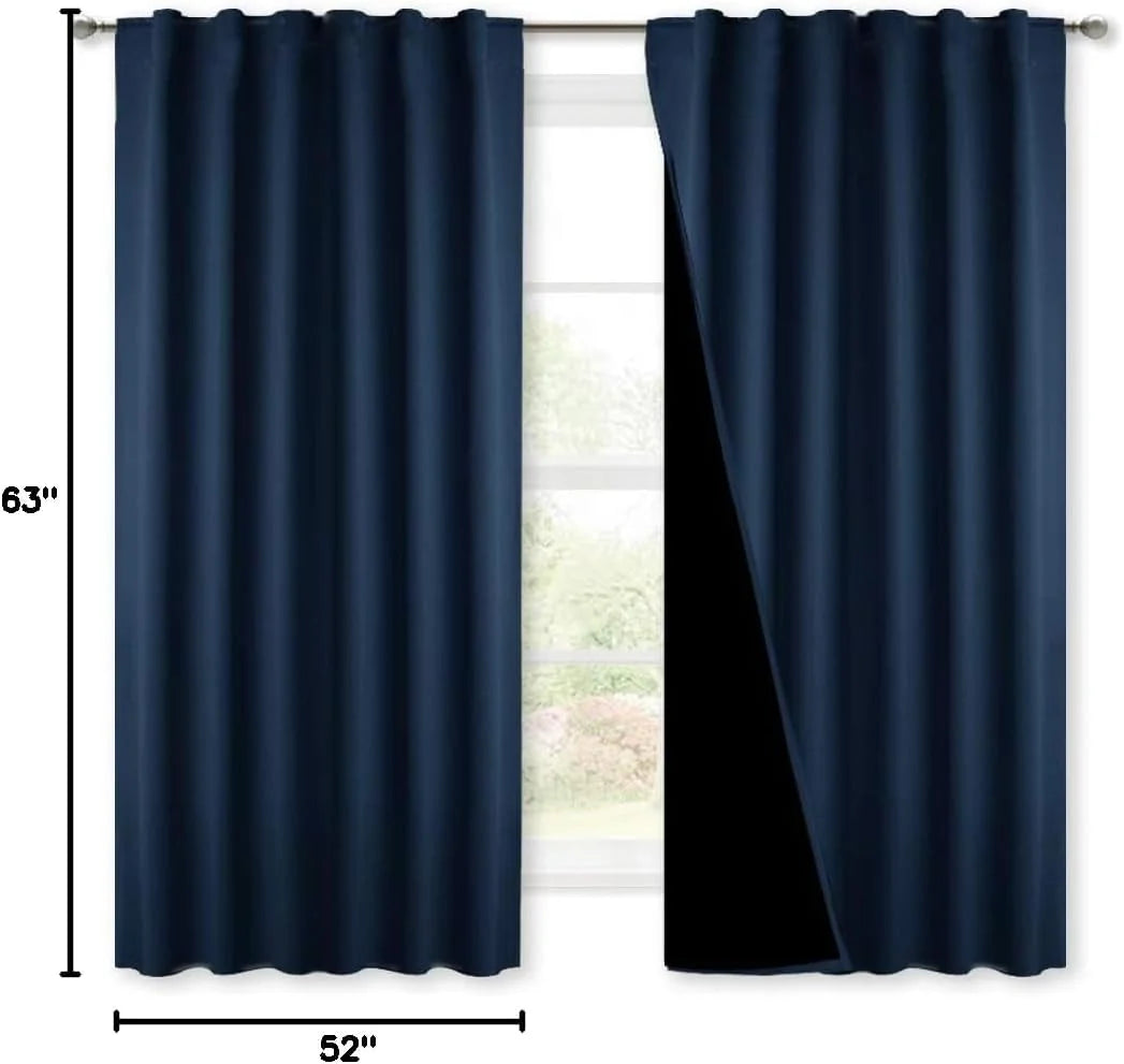 Navy blue blackout curtain panels on a silver rod with pleated top and black lining