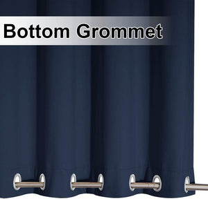 Close-up of a navy blue curtain panel featuring silver bottom grommets and a support rod.