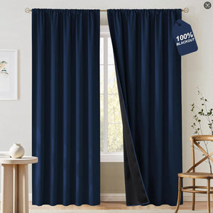 Dark navy blue blackout curtains with rod pocket top, one panel open showing black lining.