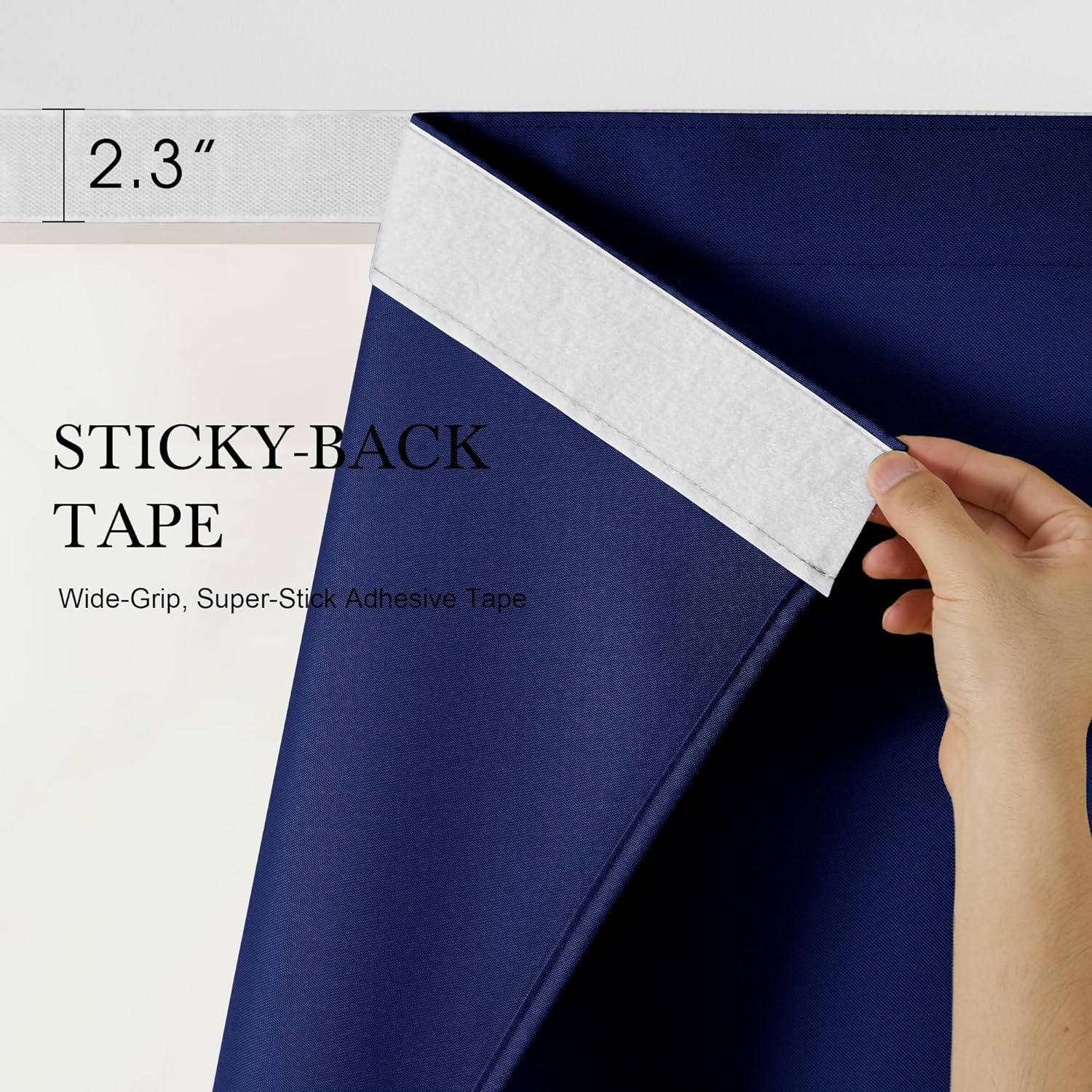 Hand peeling back a 2.3-inch wide white super-stick adhesive tape from the top edge of a navy blue blackout curtain.
