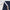 A hand peels a 2.3-inch white sticky-back adhesive tape from a navy blue curtain, highlighting its wide-grip feature.