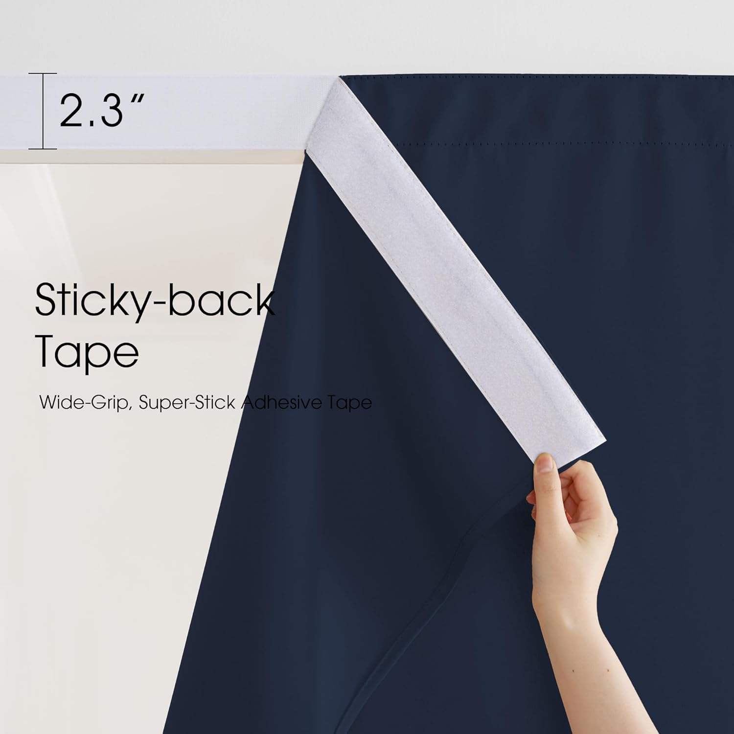 A hand peels a 2.3-inch white sticky-back adhesive tape from a navy blue curtain, highlighting its wide-grip feature.