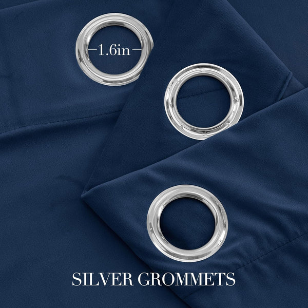 Close-up of navy blue fabric curtains with shiny silver grommets, one measured at 1.6 inches diameter.