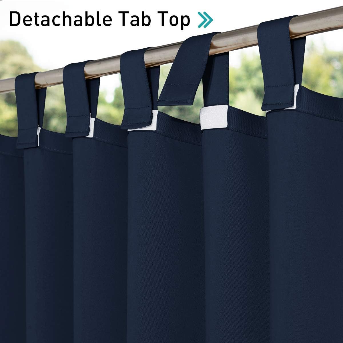 Navy blue curtains with detachable tab top loops secured by white fasteners on a gold curtain rod.