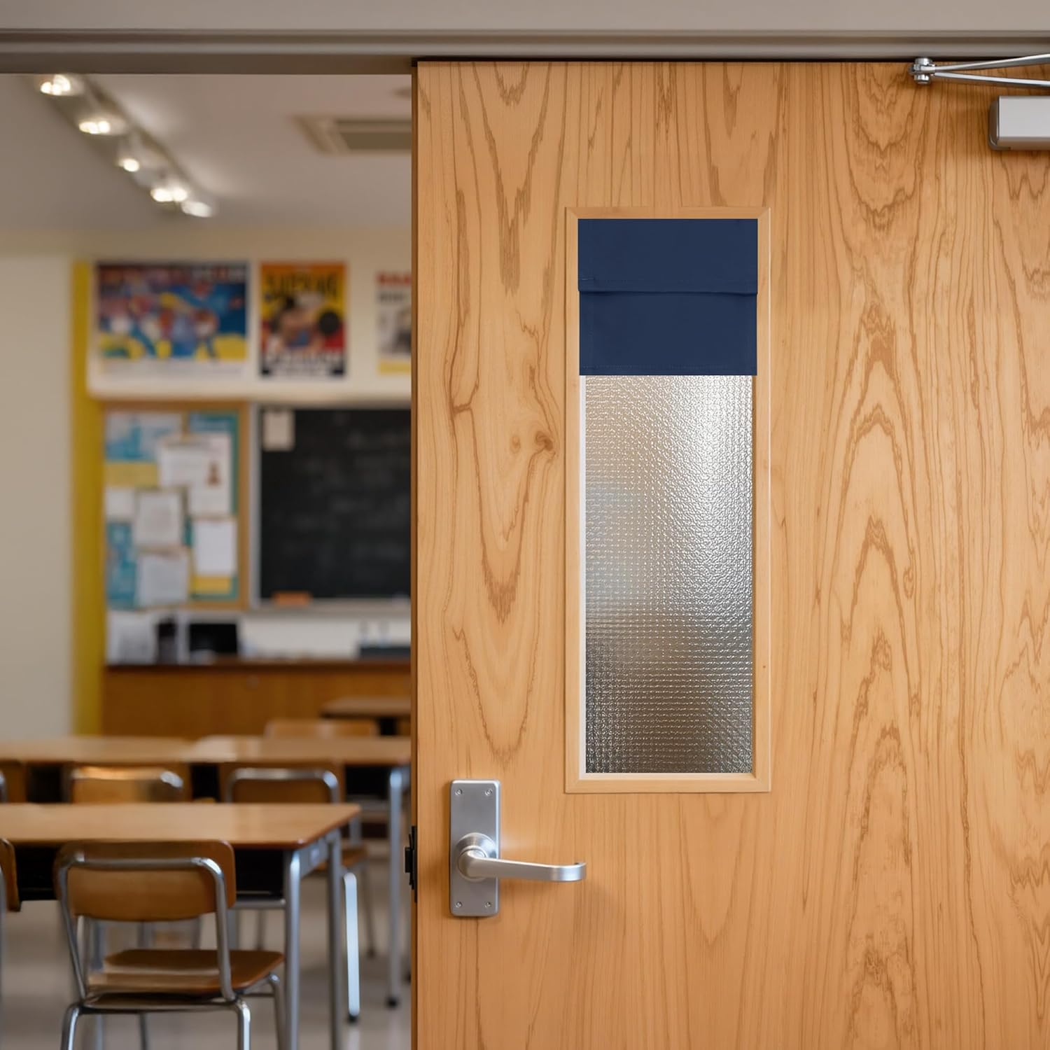 Navy blue fabric door window privacy shade covering a textured glass panel.