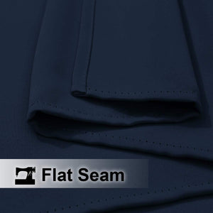 Close-up of navy blue fabric showcasing a neat, reinforced flat seam with visible stitching.
