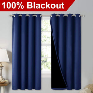 Navy blue 100% blackout curtains with silver grommets. One panel is open, showing the black lining.