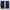 Navy blue blackout curtains with metal grommets hanging on a black window rod.
