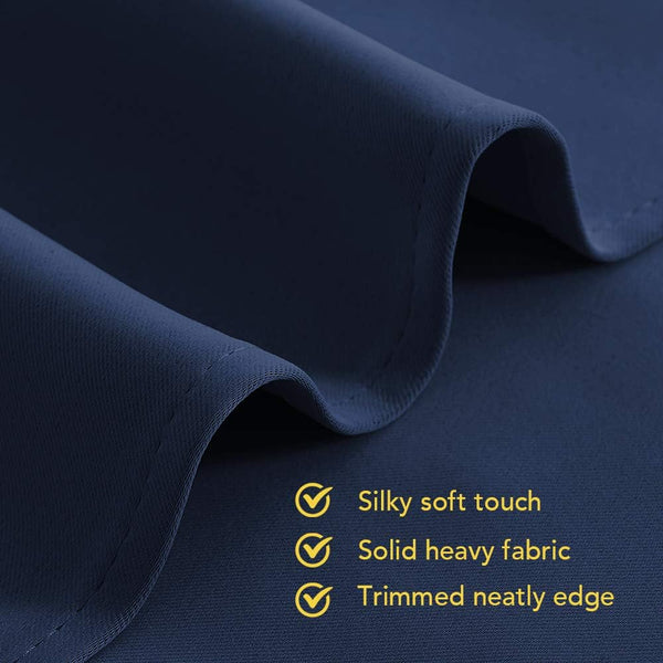 Close-up of dark navy blue heavy fabric with a silky soft touch and neatly trimmed edge.