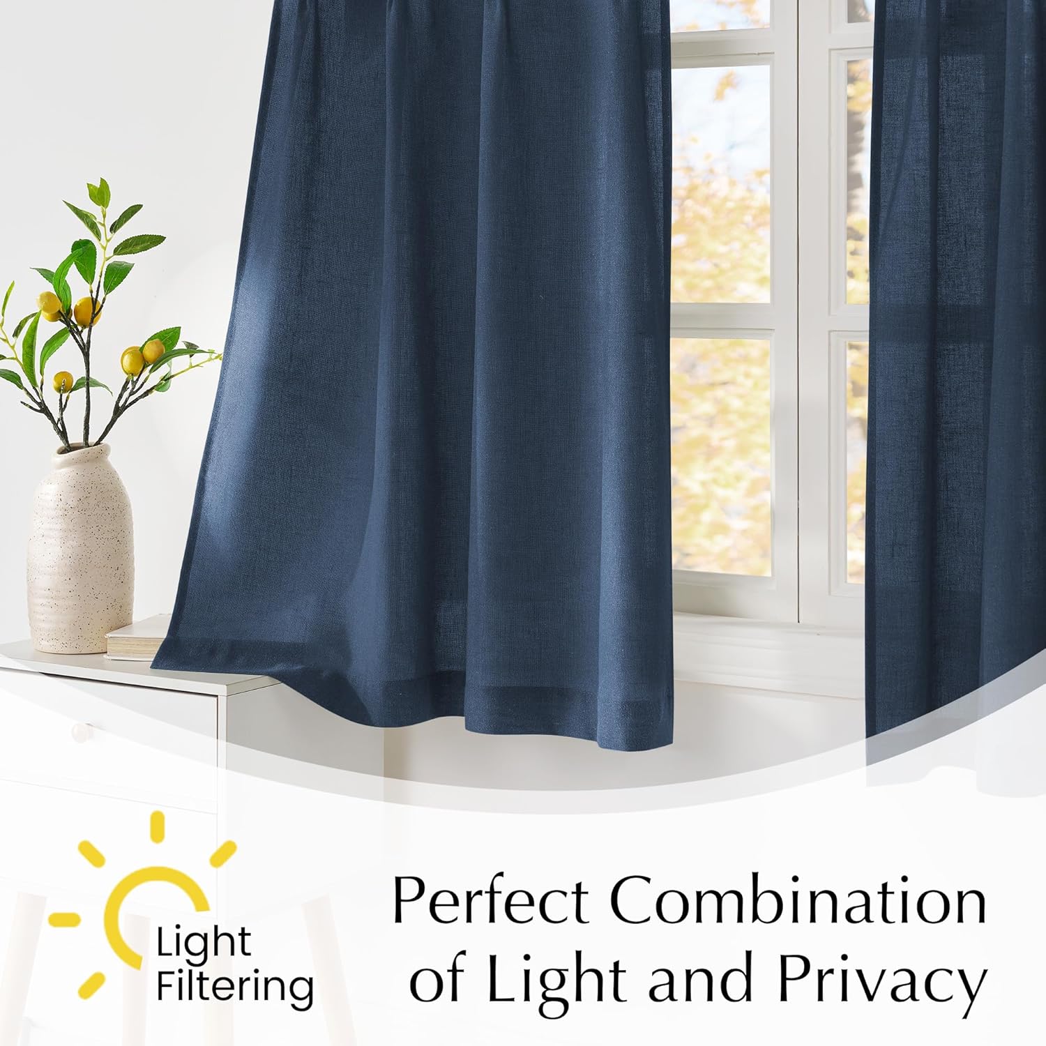 Navy blue textured linen light filtering curtains hung on a window, providing privacy and soft light.
