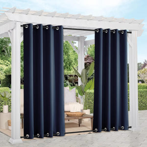 Navy blue outdoor curtains with silver grommet tops on a white pergola, providing shade and privacy.