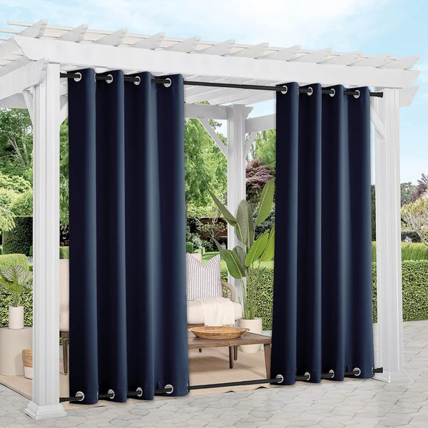 Navy blue outdoor curtains with silver grommet tops on a white pergola, providing shade and privacy.