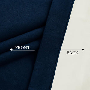 Close-up of a dark navy plush blackout fabric, displaying its textured front and smooth light-colored back.