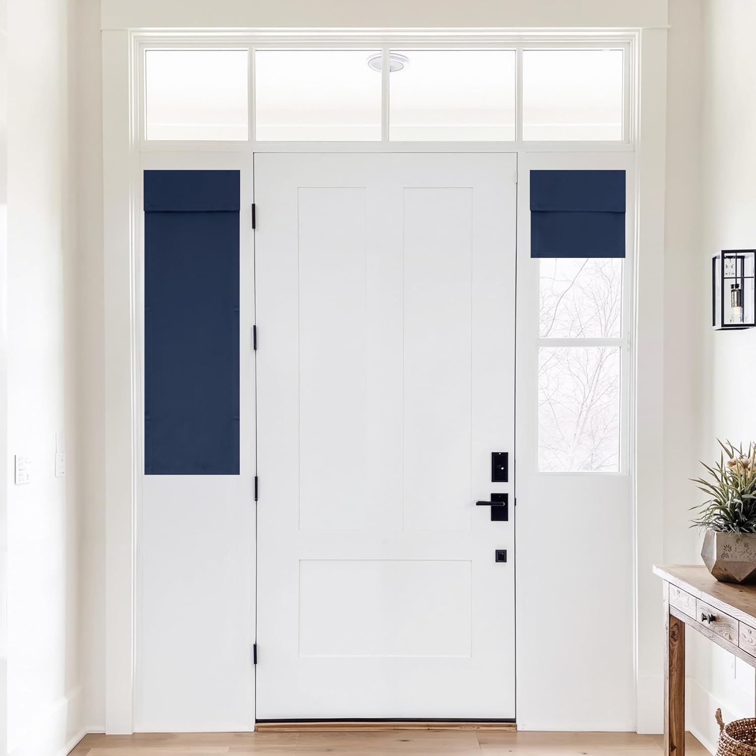 Navy blue privacy shades on sidelight windows flanking a white modern front door in a bright entryway.