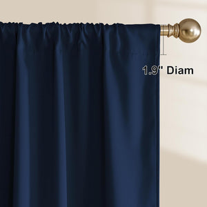 Navy blue curtain panel with rod pocket header, hanging on a brass rod. 1.9 inch diameter shown.
