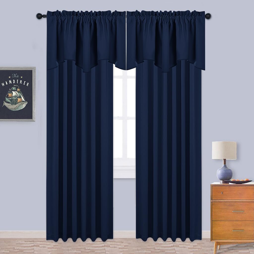 Navy blue rod pocket curtains with a matching layered valance cover a window in a contemporary room.