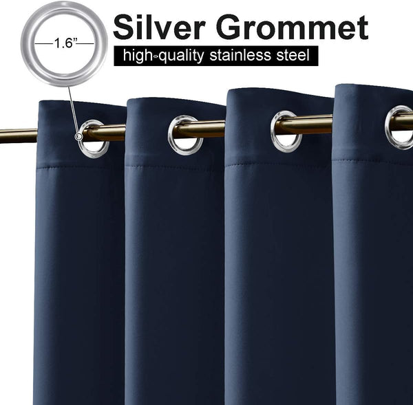 Close-up of navy blue curtains with 1.6-inch silver stainless steel grommets, hanging from a gold rod.