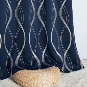 Modern navy blue curtain with shimmering silver wavy line pattern, draped over a woven pouf.