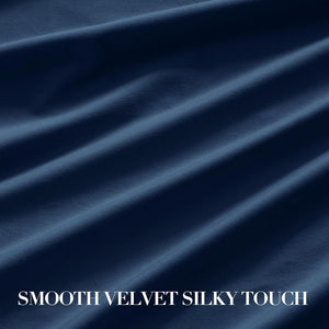Close-up of smooth, silky navy blue velvet fabric with gentle folds, highlighting its soft texture.