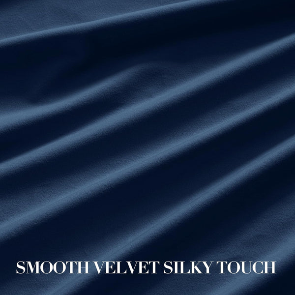 Close-up of smooth, silky navy blue velvet fabric with gentle folds, highlighting its soft texture.