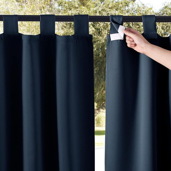 Navy blue tab top curtains with hook-and-loop fasteners. A hand is shown opening one tab against a green outdoor background.