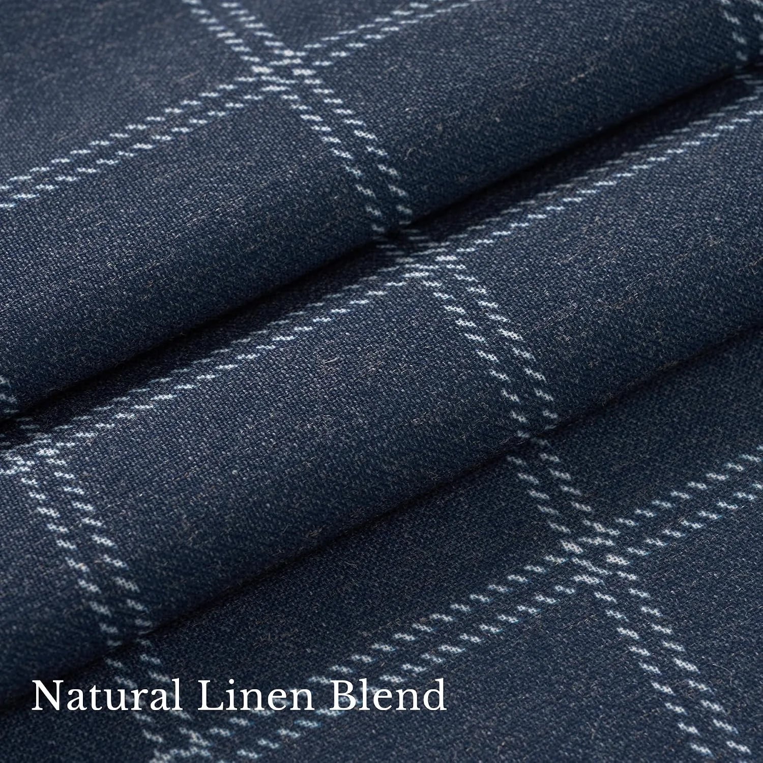 Close-up of navy linen blend fabric with white windowpane plaid pattern