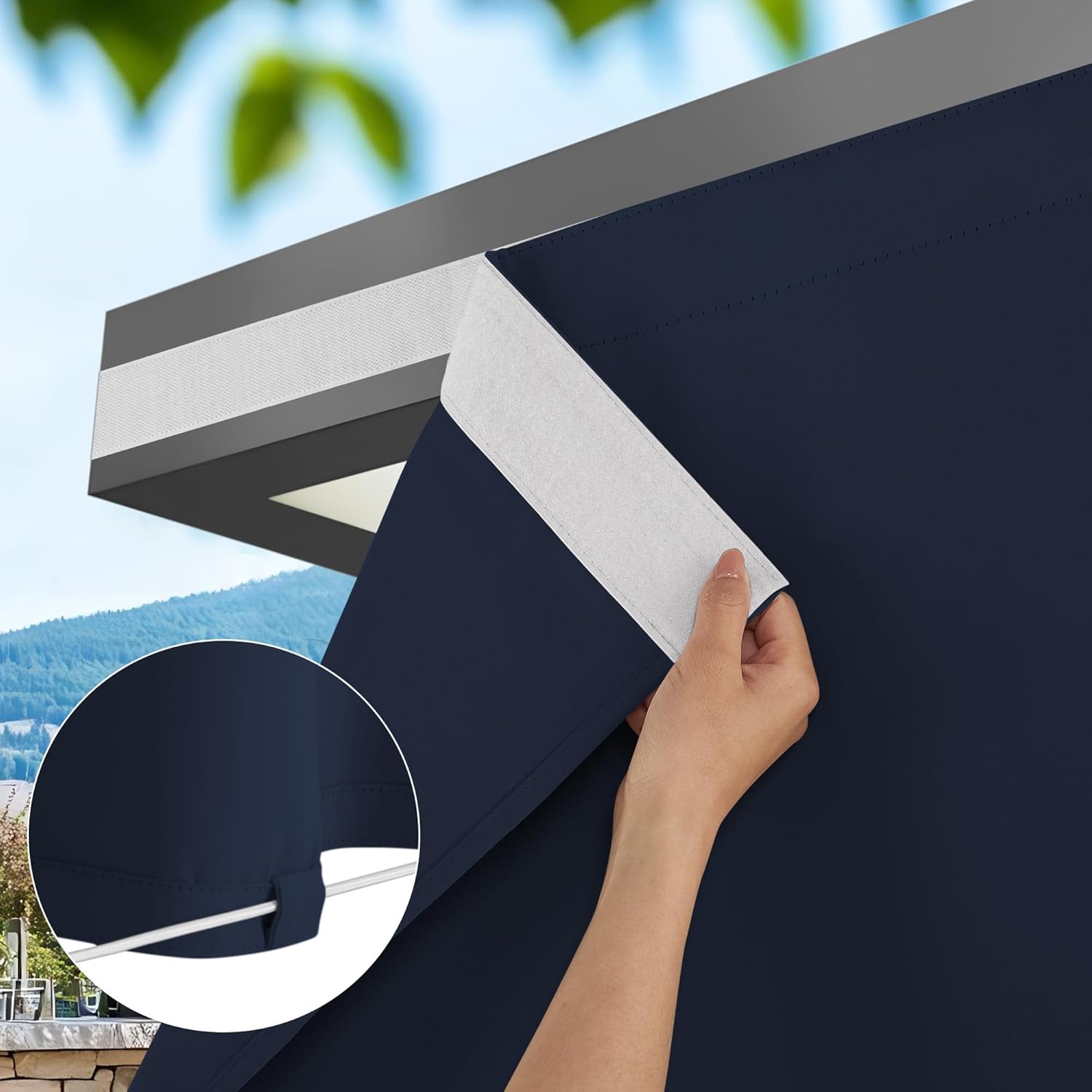 Navy blue outdoor privacy curtain with white hook-and-loop top fastener. Bottom loops for a tension rod are visible.