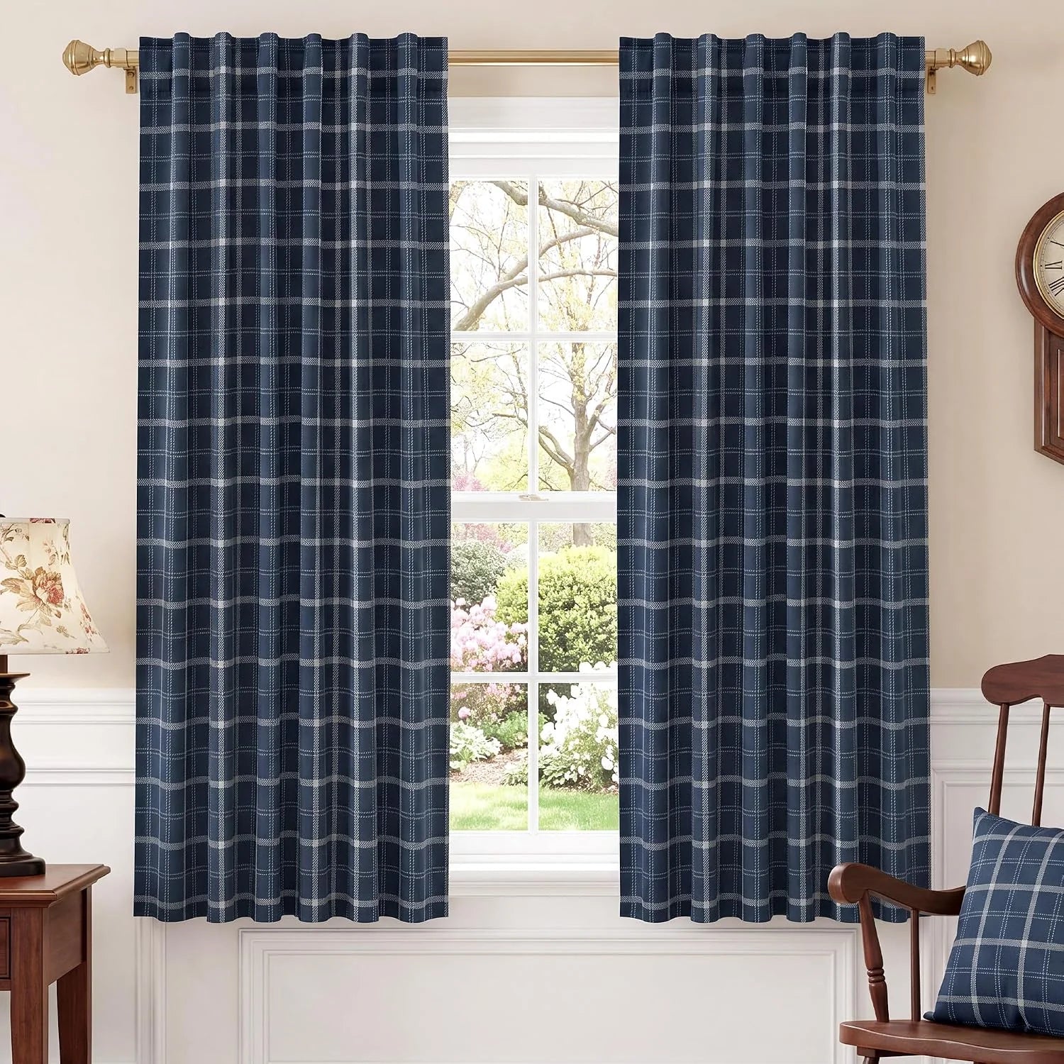 Navy blue plaid curtains on a brass rod in a bright traditional room