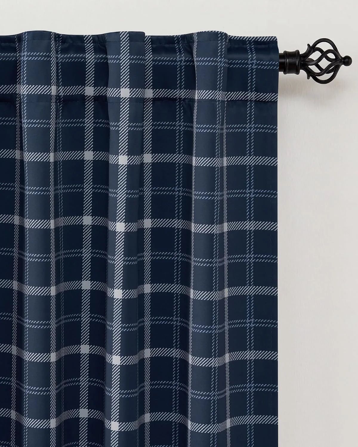 Navy plaid curtain panel with rod pocket hanging on a black decorative curtain rod