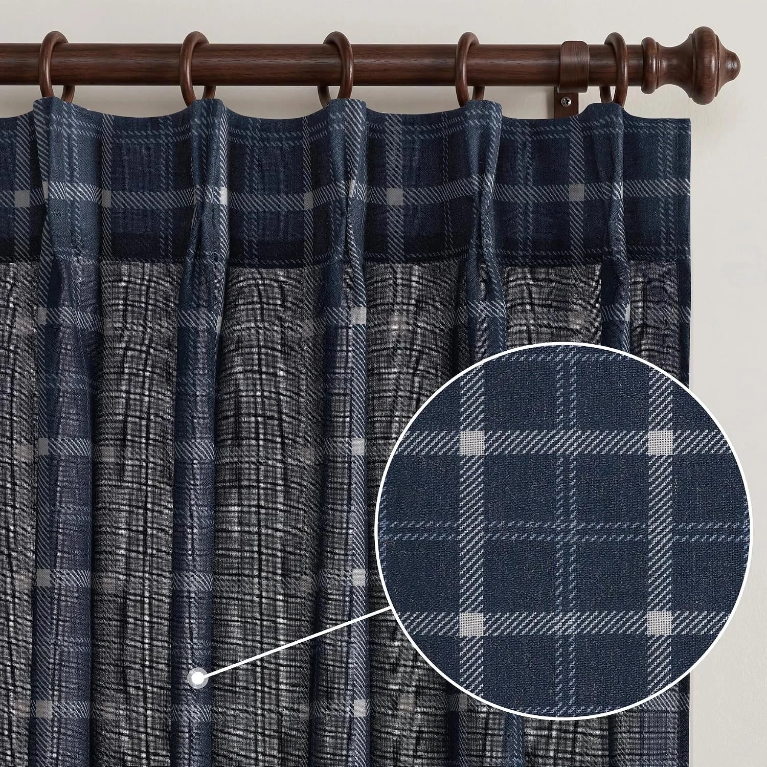 Navy plaid sheer curtain panel on a dark wood rod with ring top hanging