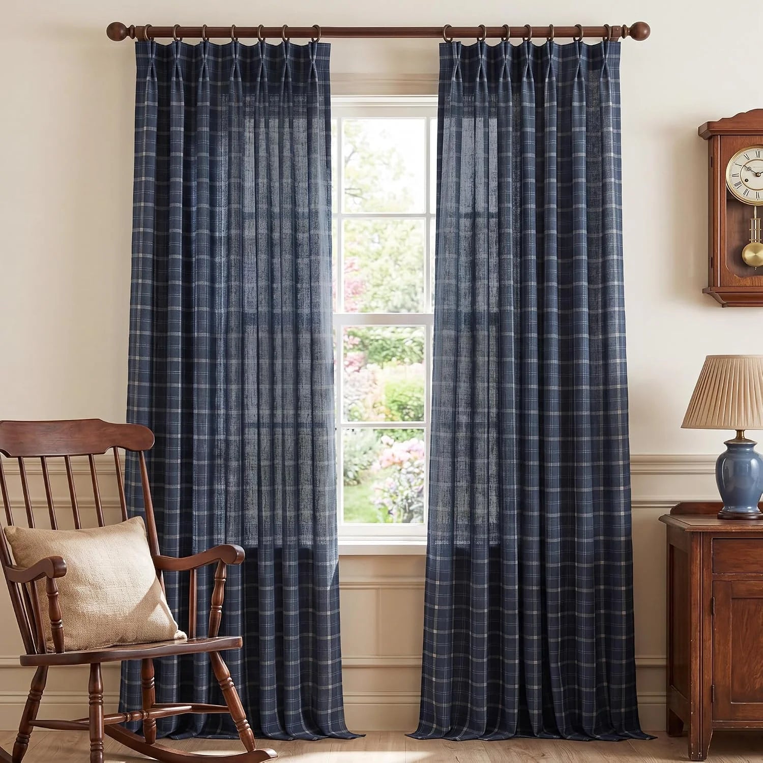 Navy plaid sheer curtains on a wooden rod in a cozy traditional room