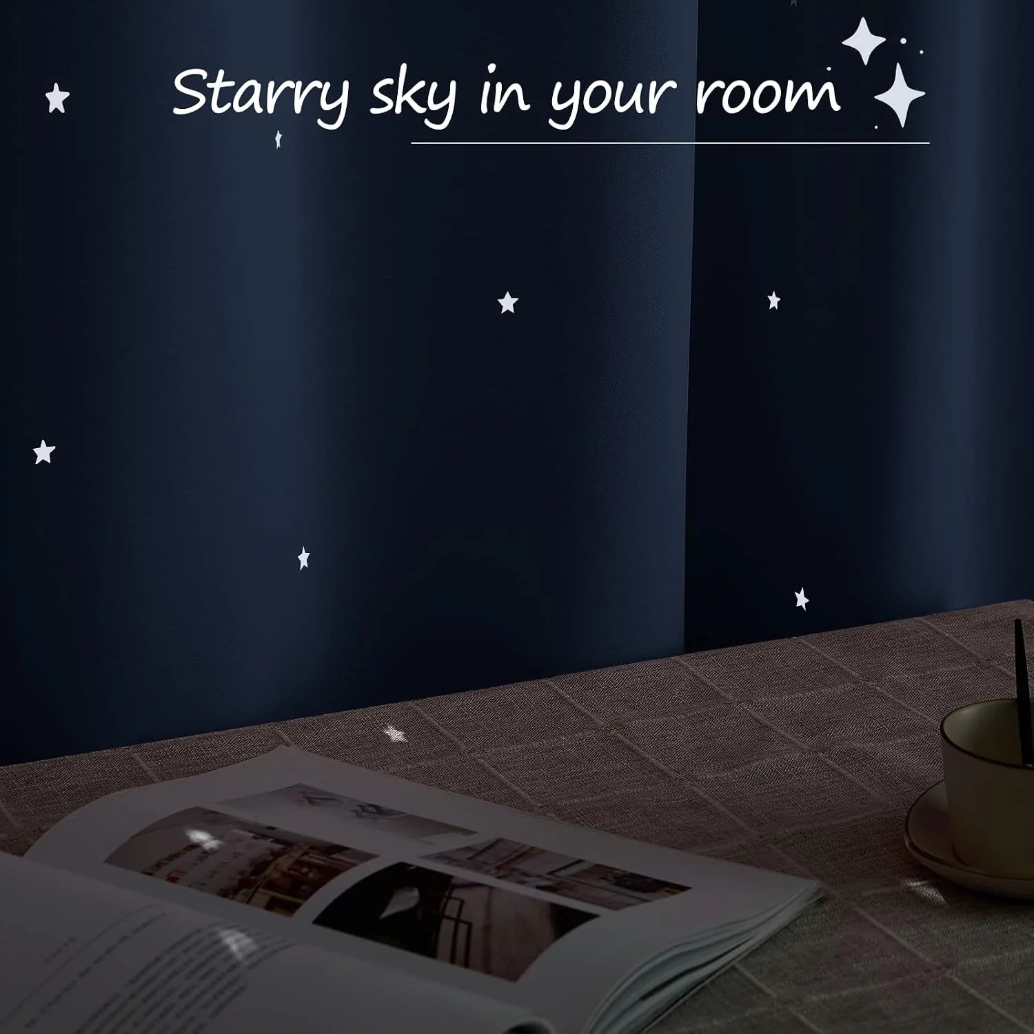 Navy blackout curtains with star cutouts casting light onto a table in a dark room