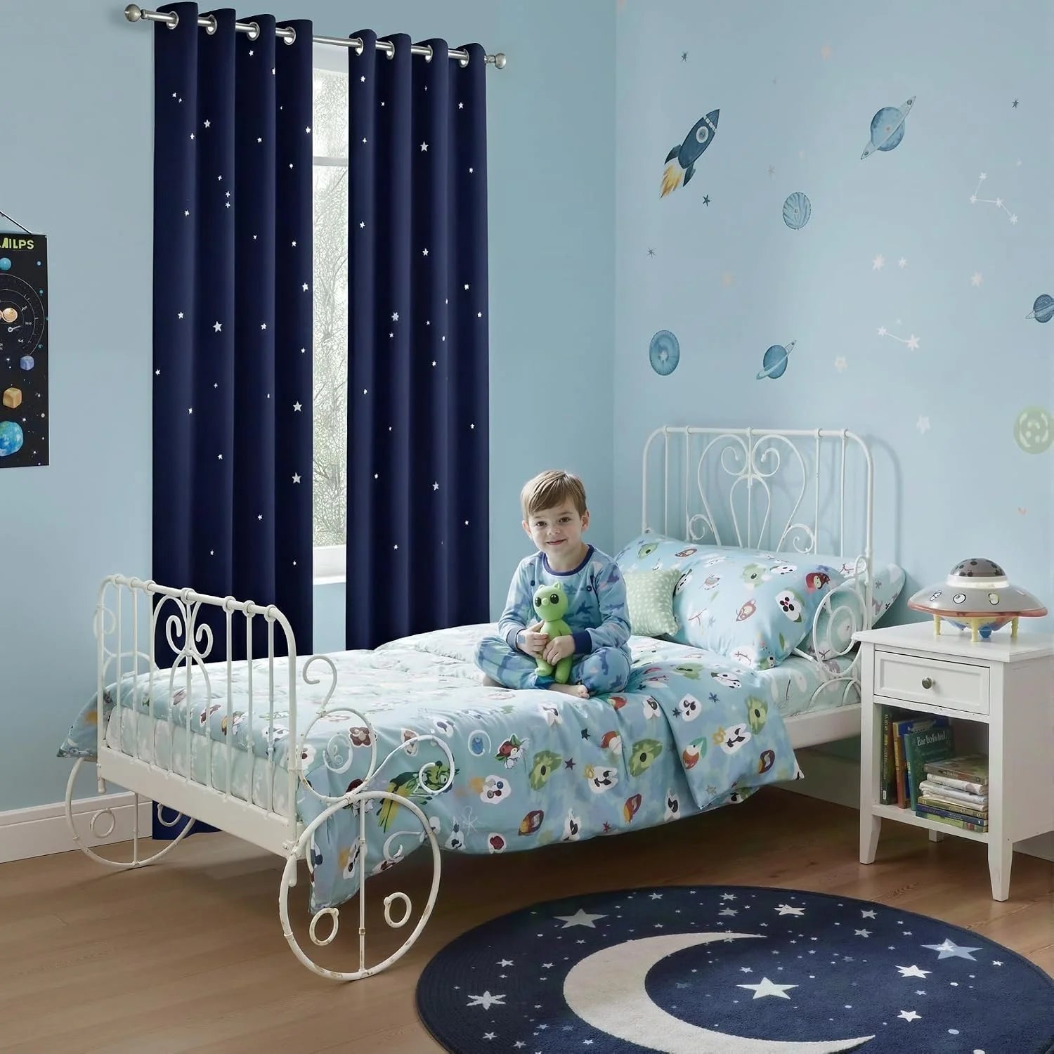 Navy star-print blackout curtains in a light blue kids bedroom with space decor
