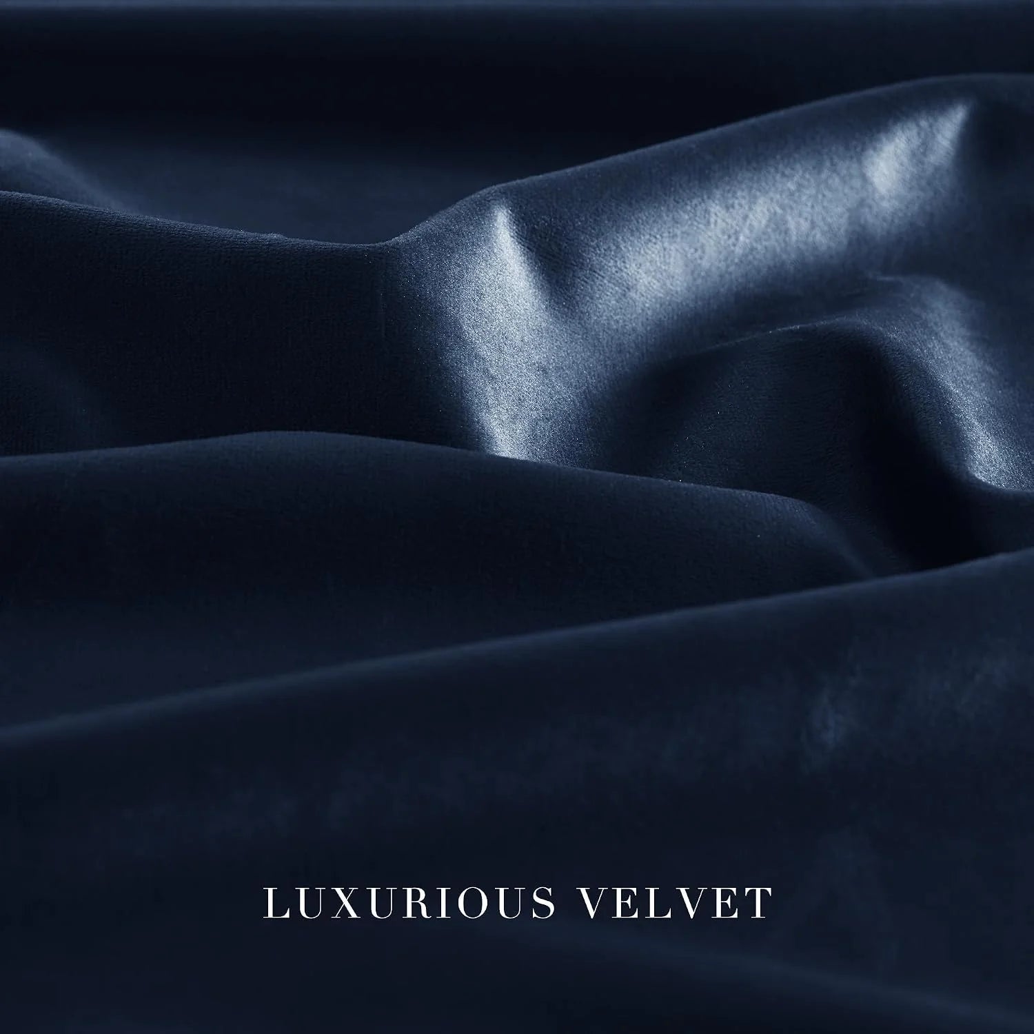 Close-up of navy blue velvet fabric with soft folds and a smooth, luminous sheen